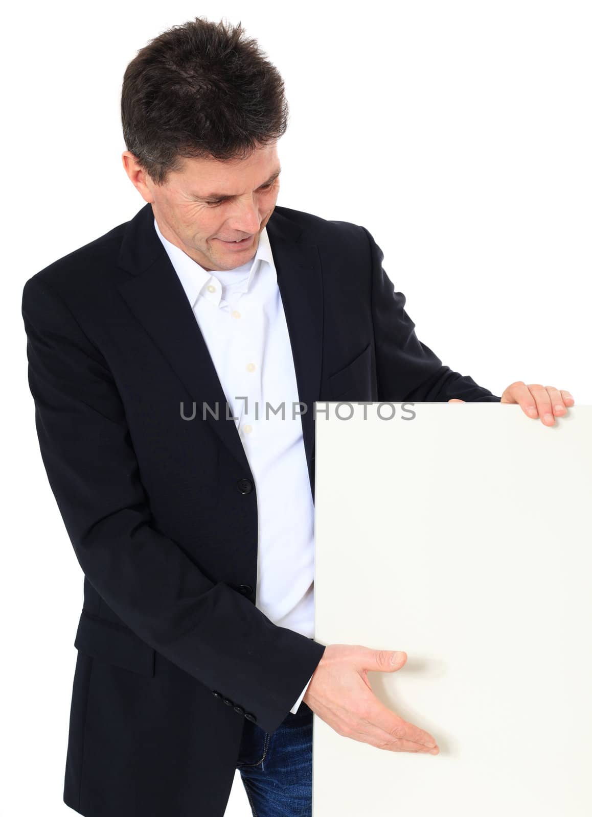 Attractive middle-aged man pointing on white board. All on white background.