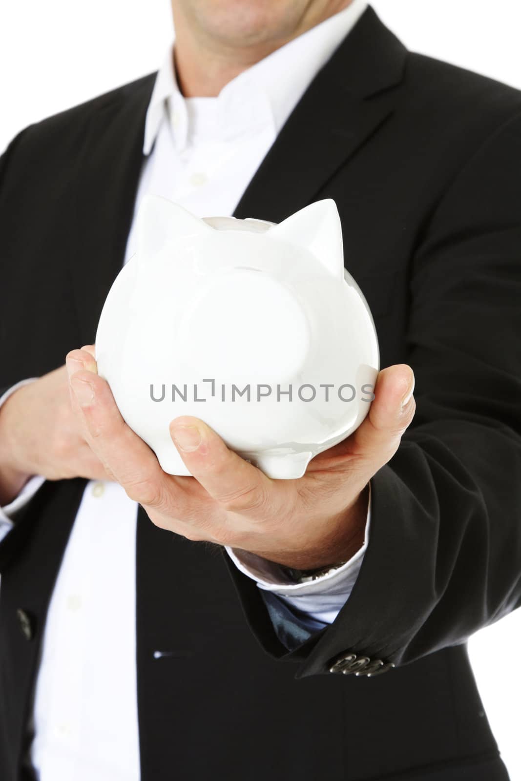 Middle-aged man holding piggy bank. All on white background. Selective focus on piggi bank in foreground.