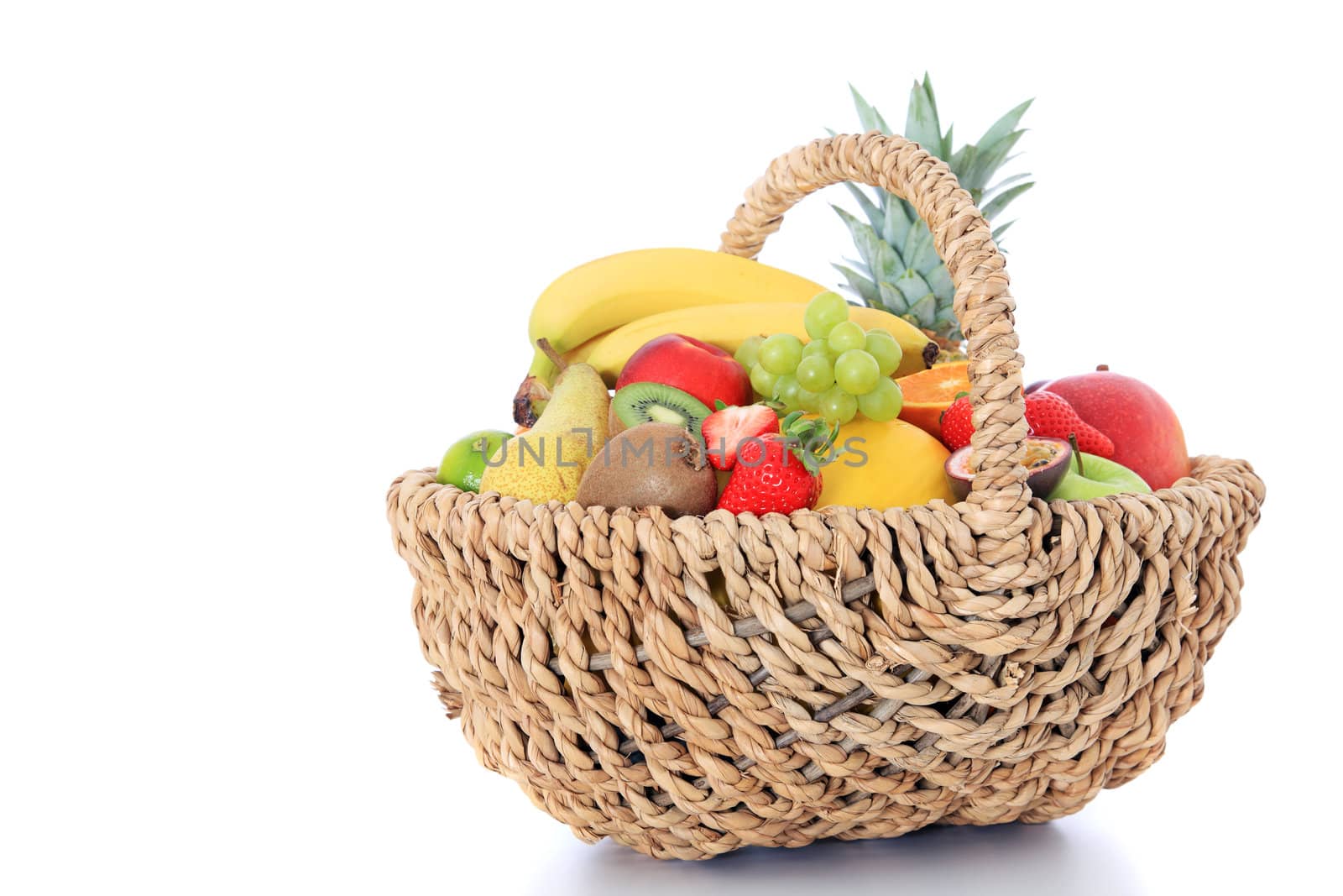 Basket full of various ripe fruits. Isolated on white background.