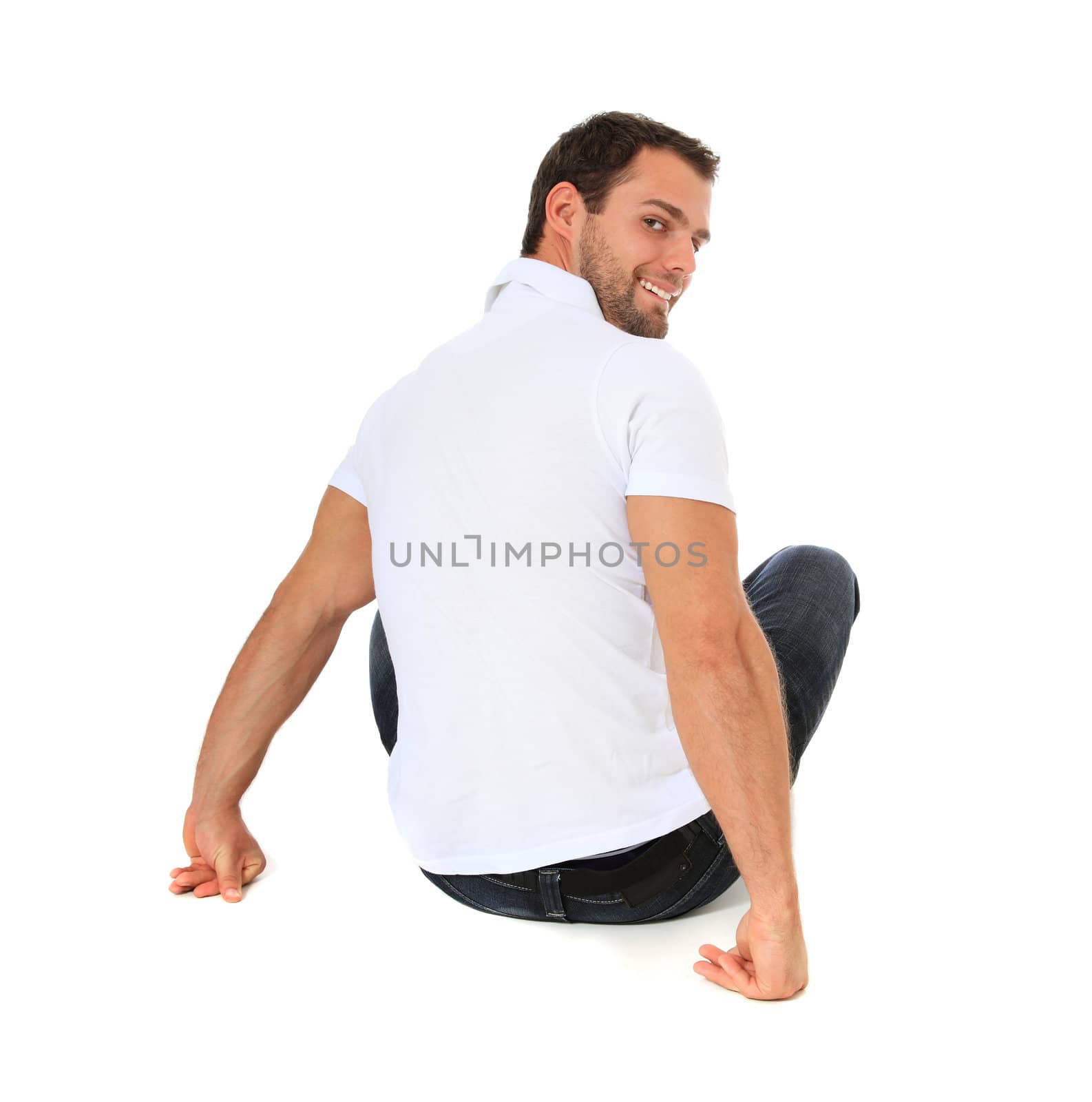Full length shot of a young man sitting on the floor. All on white background.
