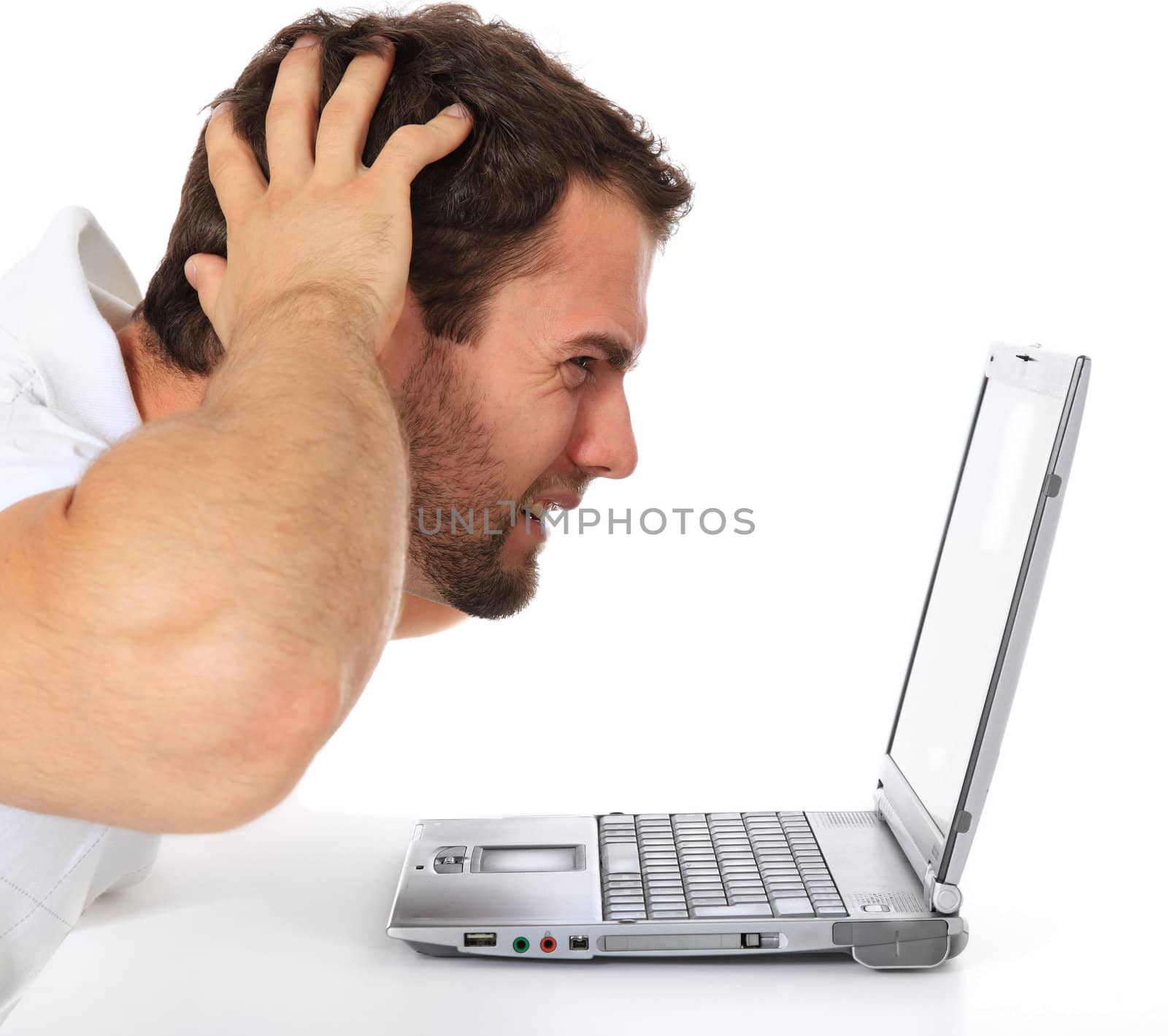 Frustrated man sitting in front of his laptop. All on white background.