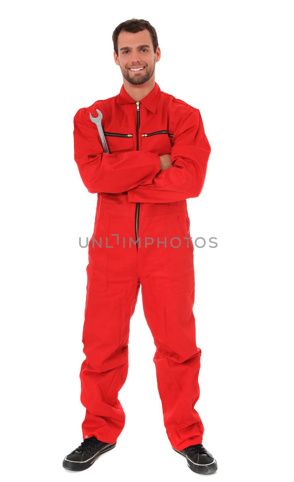 Full length shot of a smiling mechanic. All on white background.