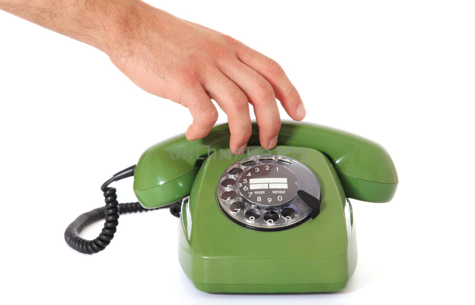 A persons hand grabs 70s-fashioned telephone handset. All on white background.