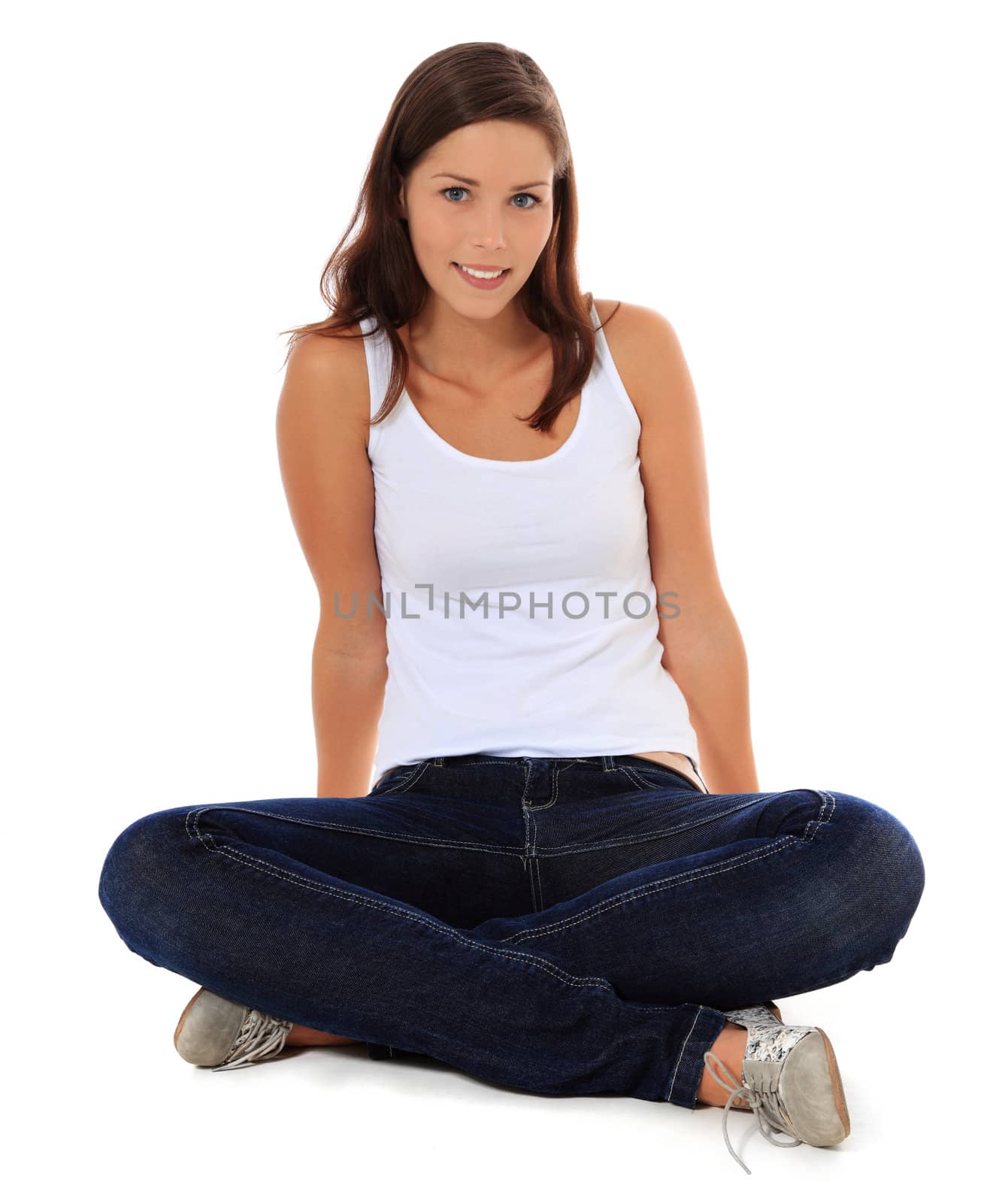 Attractive young woman sitting on the floor. All on white background.