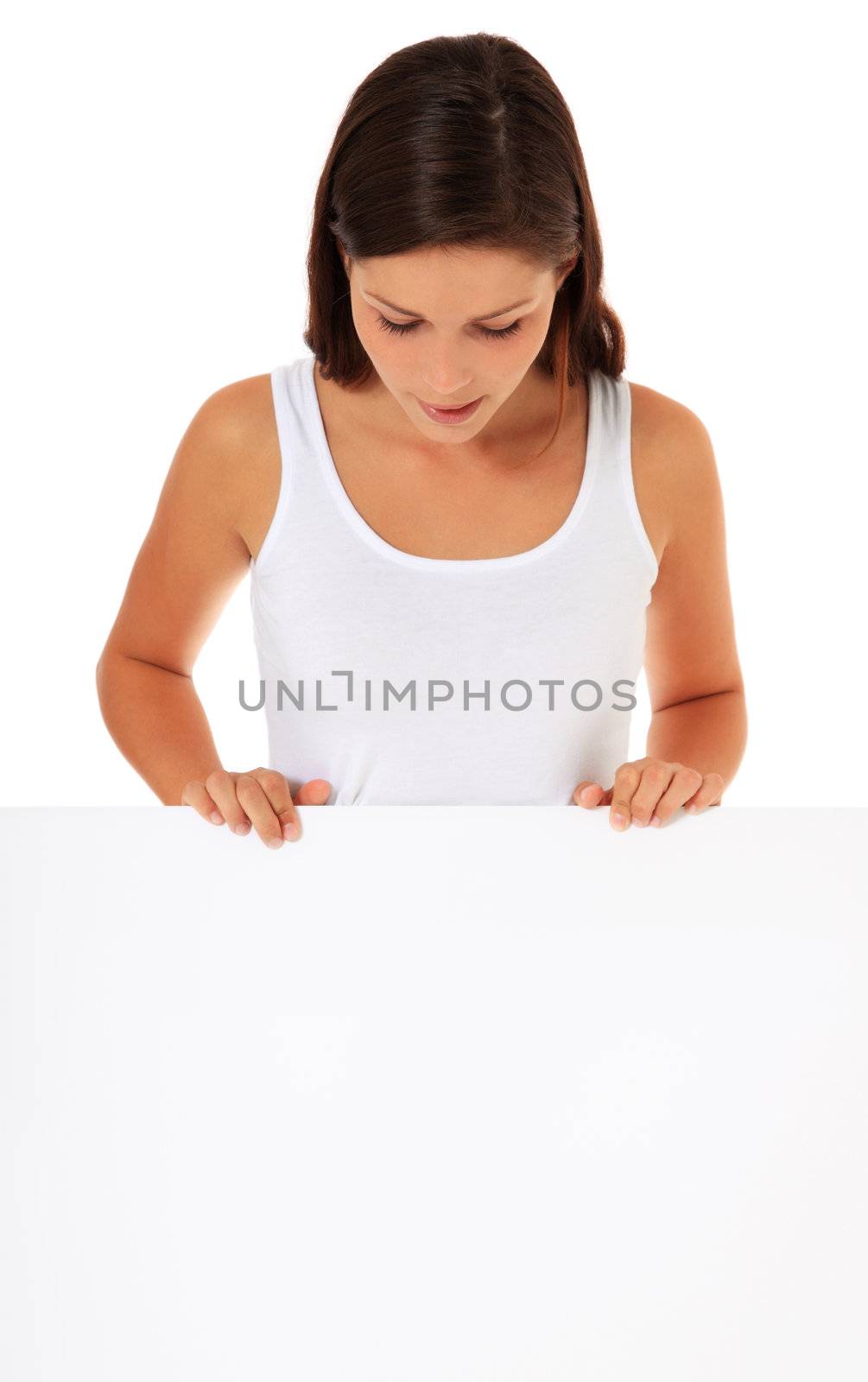 Attractive young woman looking down blank white sign. All on white background.