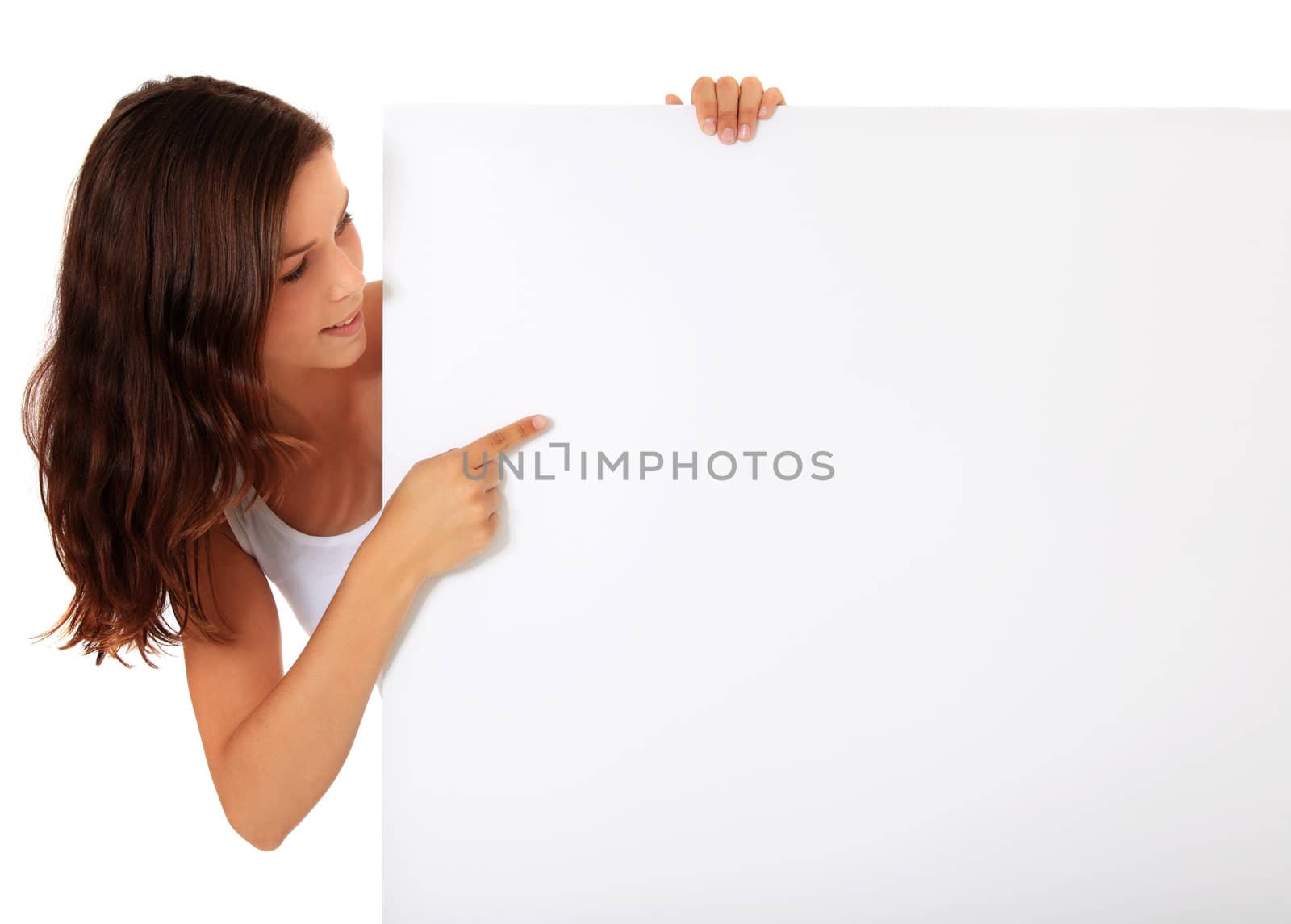Attractive young woman pointing at blank white sign. All on white background.