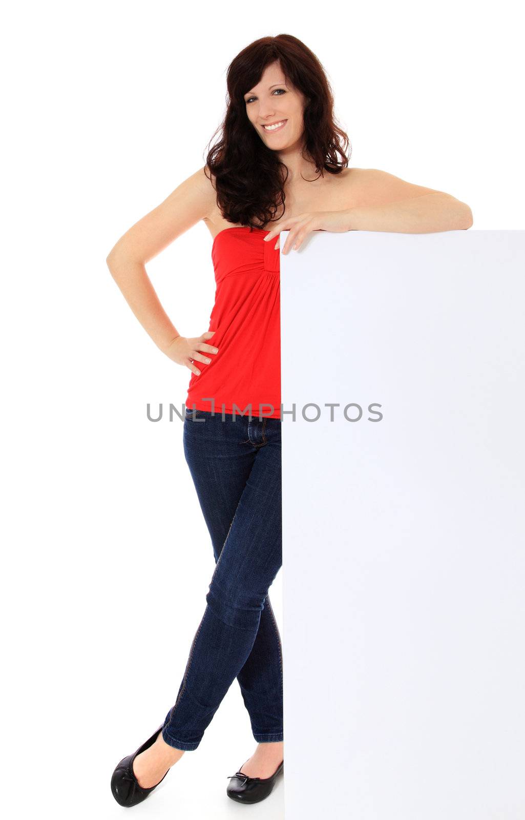 Attractive young woman standing next to blank white sign. All on white background.