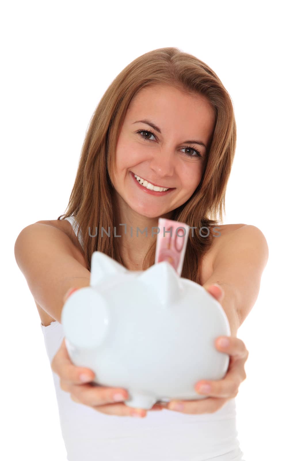 Attractive brunette girl holding her piggy bank. All on white background.