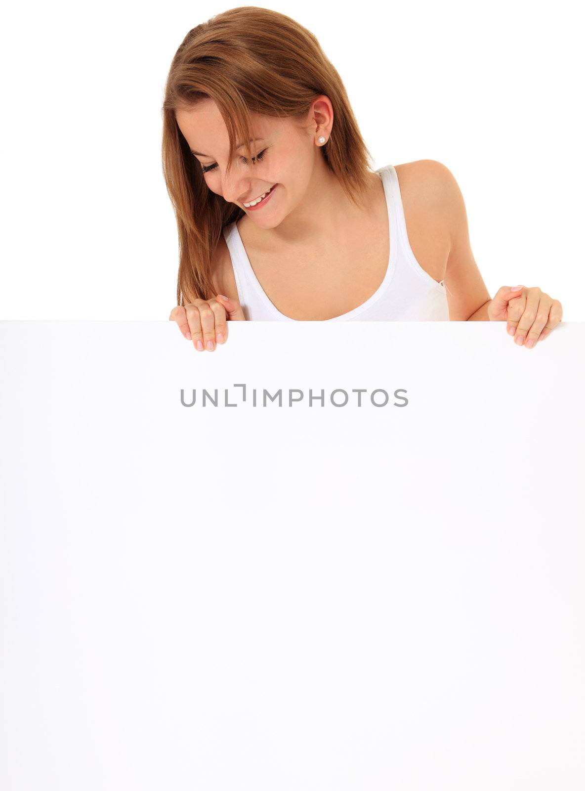 Attractive young woman looking down a blank sign with plenty copy space. All on white background.