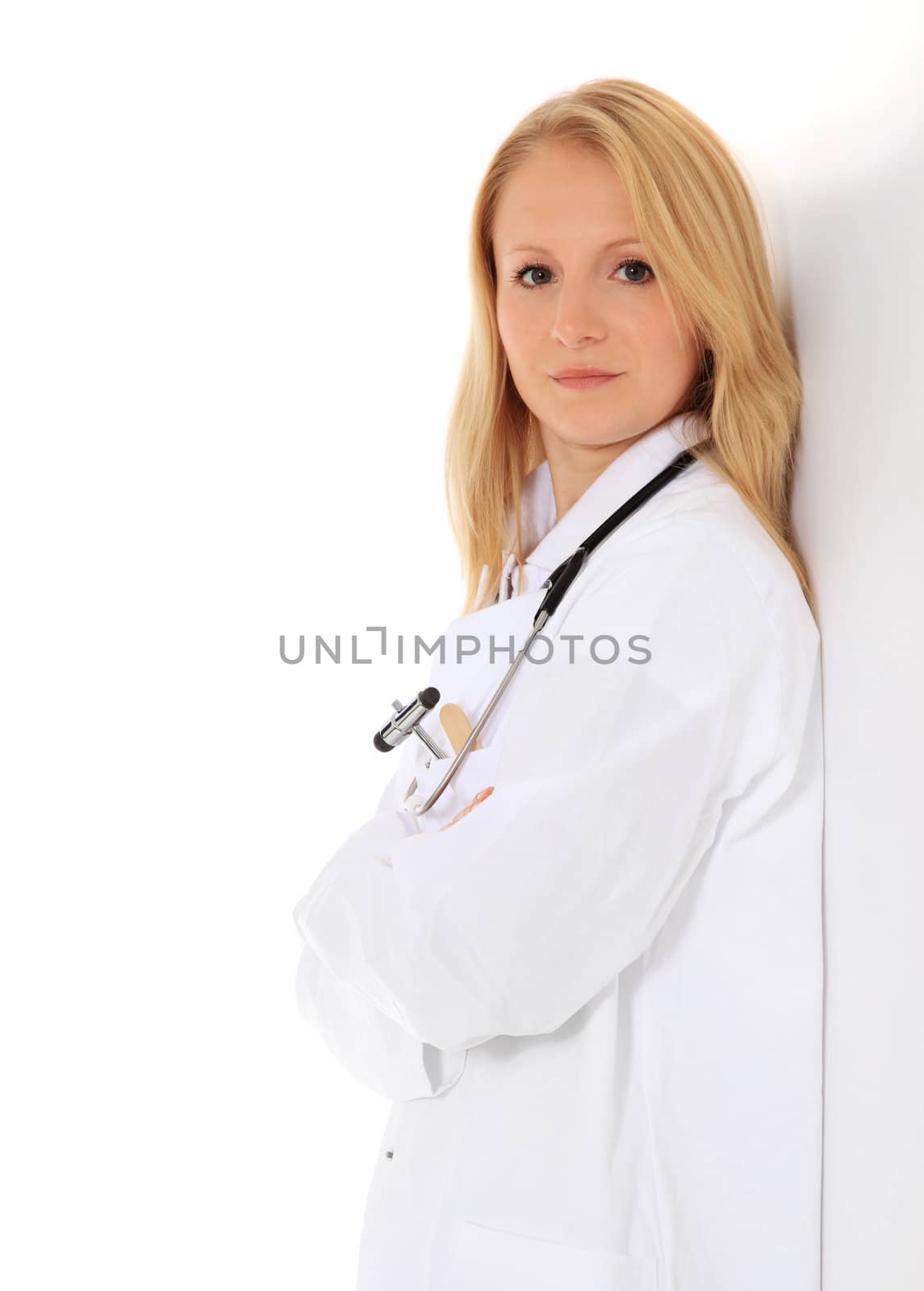 Competent young medical student leaning to the wall. All on white background.