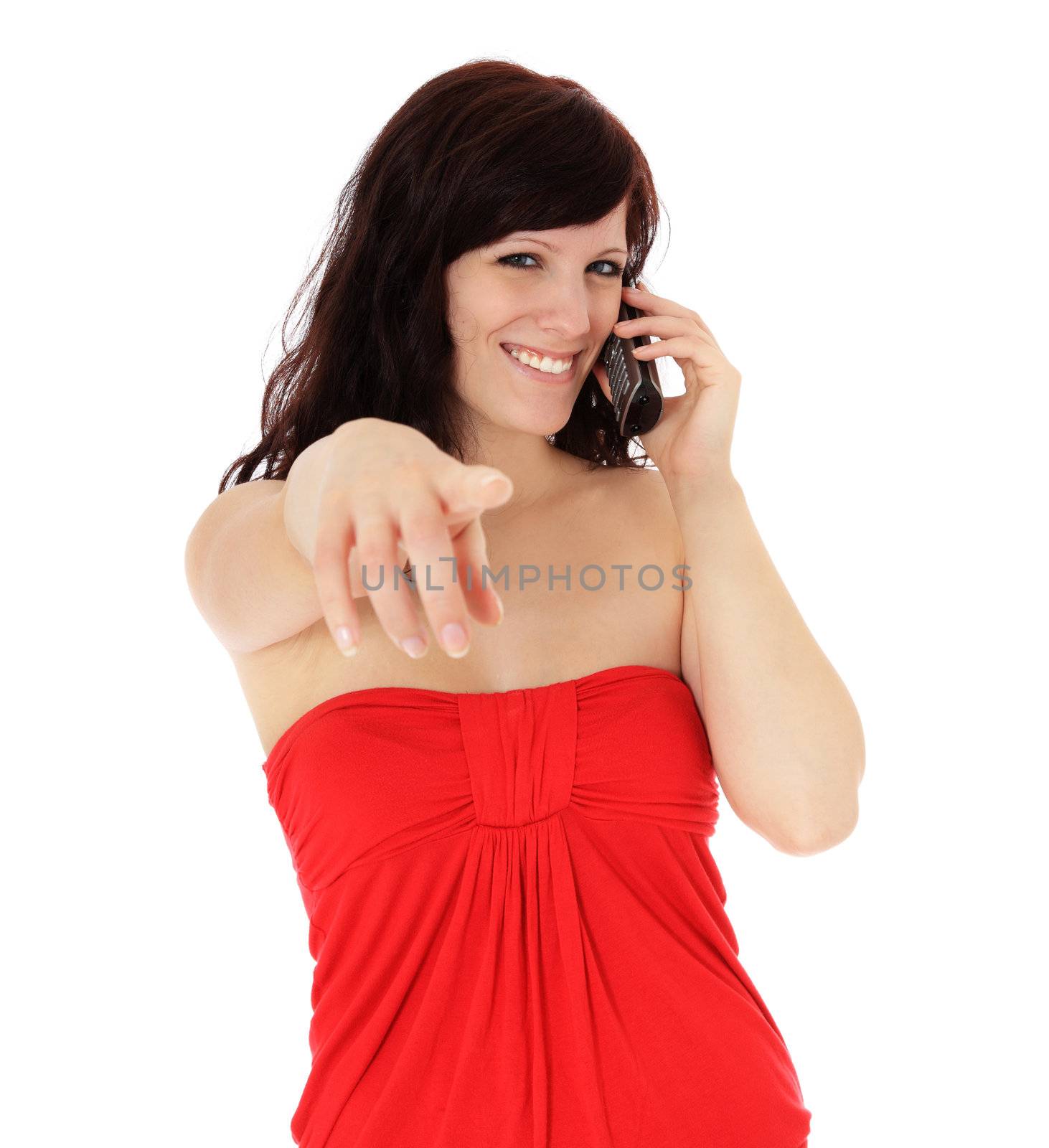 Attractive young woman pointing with finger while talking on the phone. All on white background.