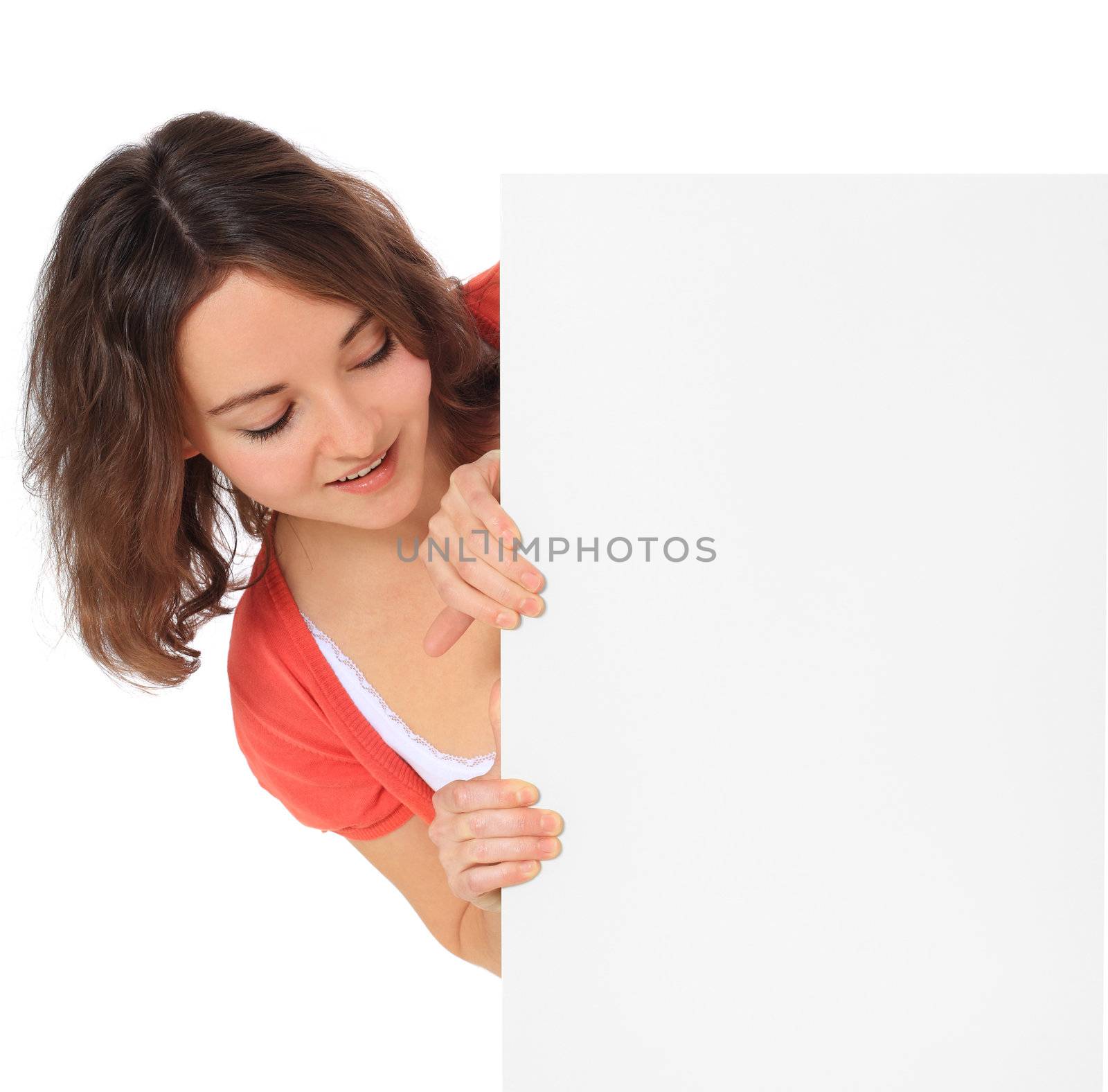 Attractive young woman standing behind white board. All on white background.
