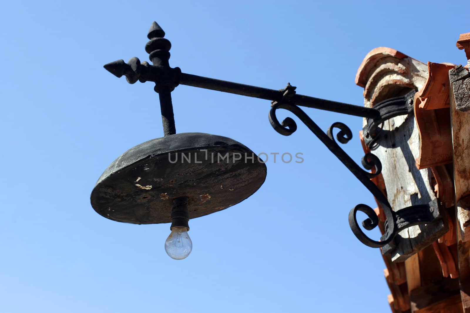 old forged lantern in Old Nessebar on blue sky