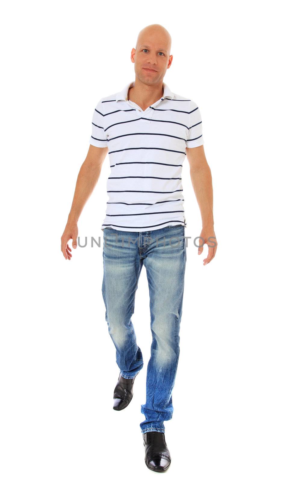 Full length shot of an attractive man walking. All on white background.