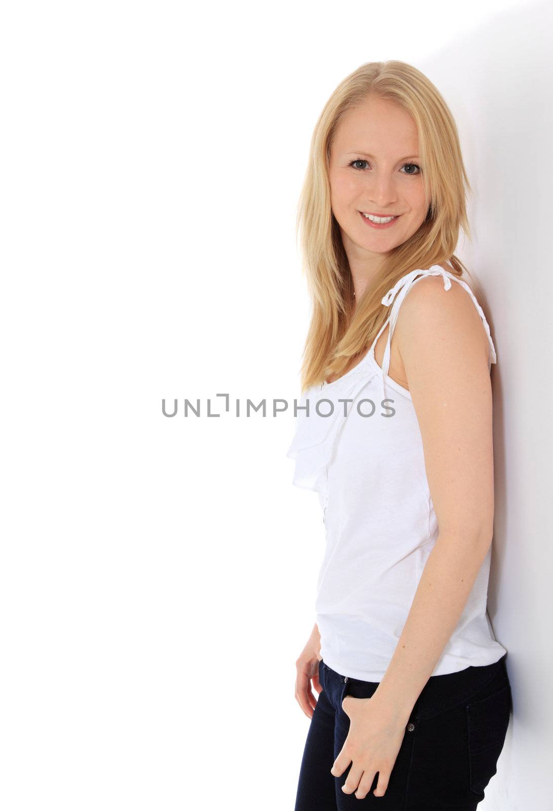 Attractive girl leaning against a wall. All on white background.