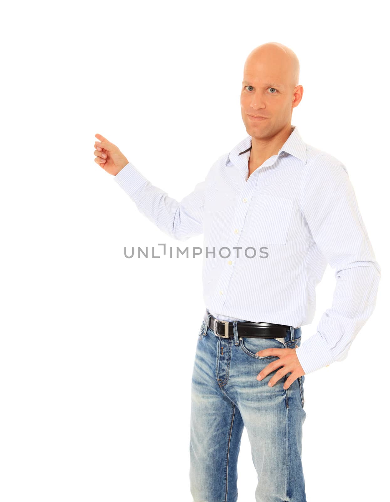 Smiling young guy pointing with finger. All on white background.