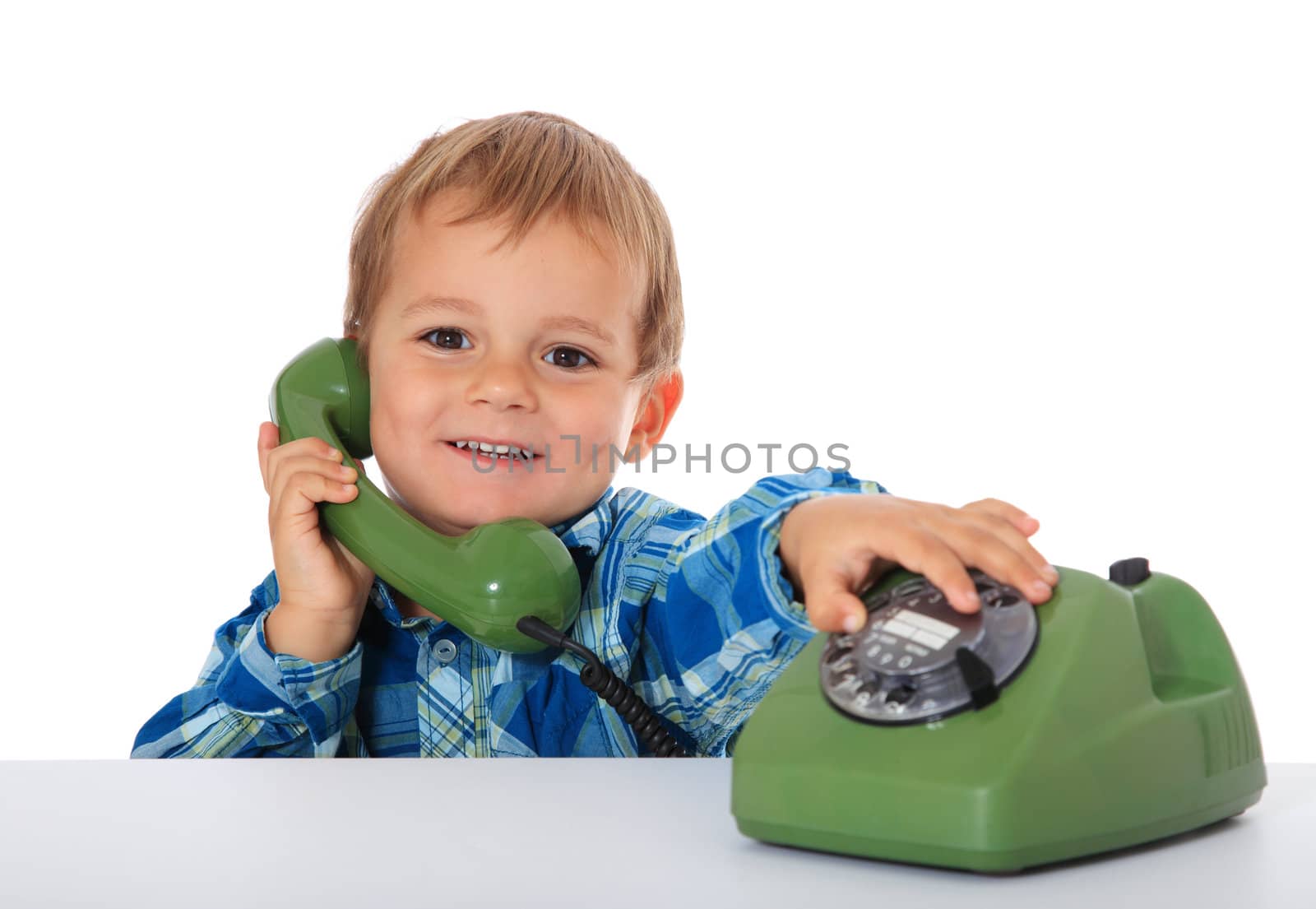 Cute caucasian boy using telephone. All on white background.