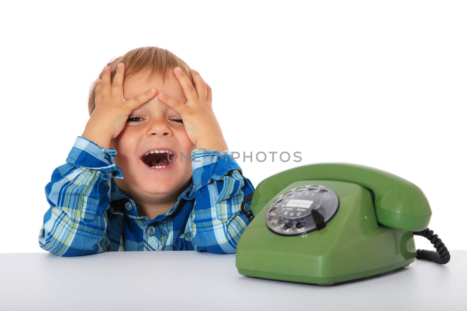 Cute caucasian boy using telephone. All on white background.