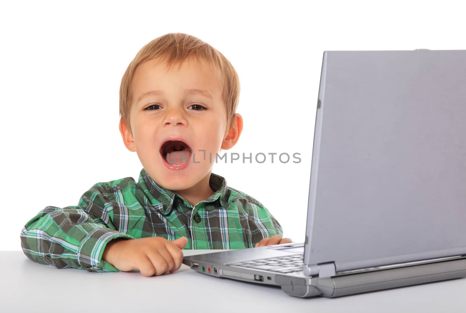 Cute caucasian boy using laptop. All on white background.