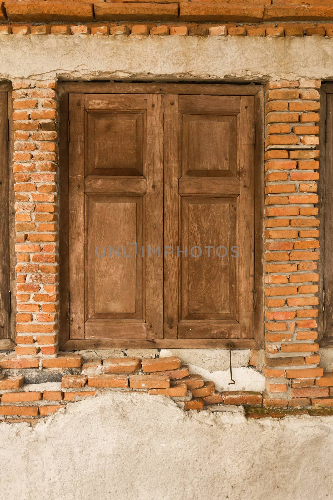 Old wooden window on old brick wall