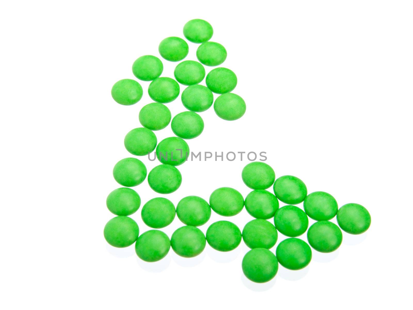 green tablets in arrow formation, isolated on white background