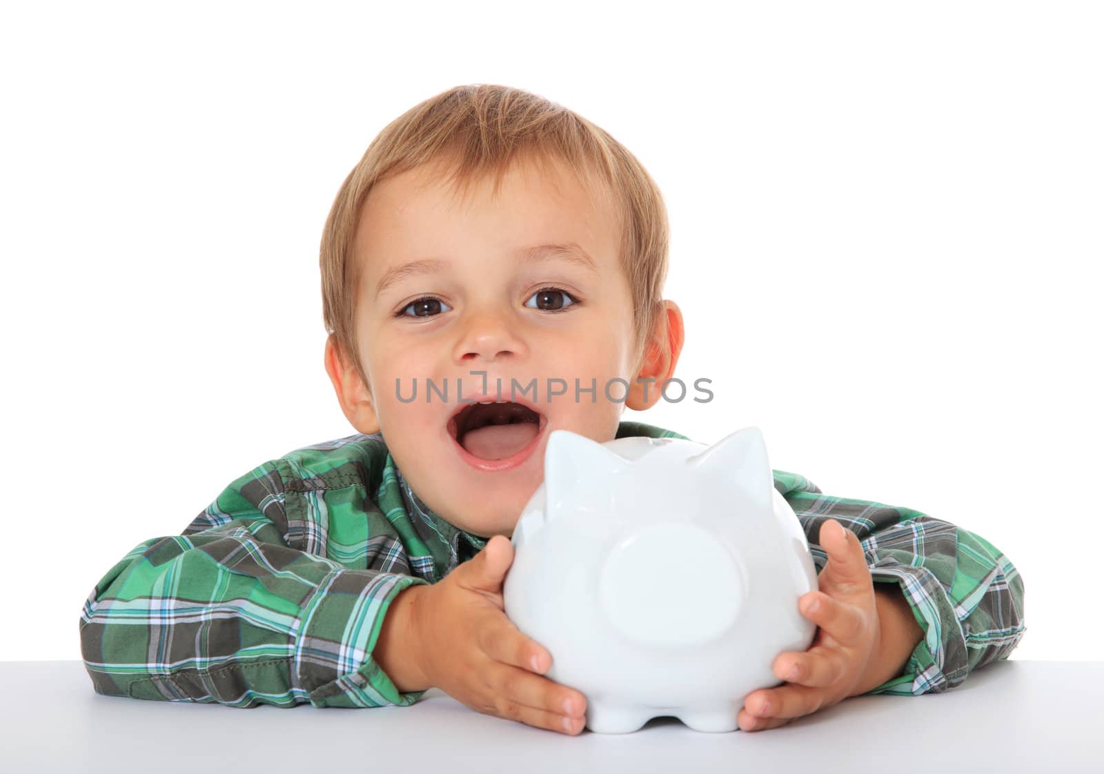 Cute caucasian boy holding piggy bank. All on white background.