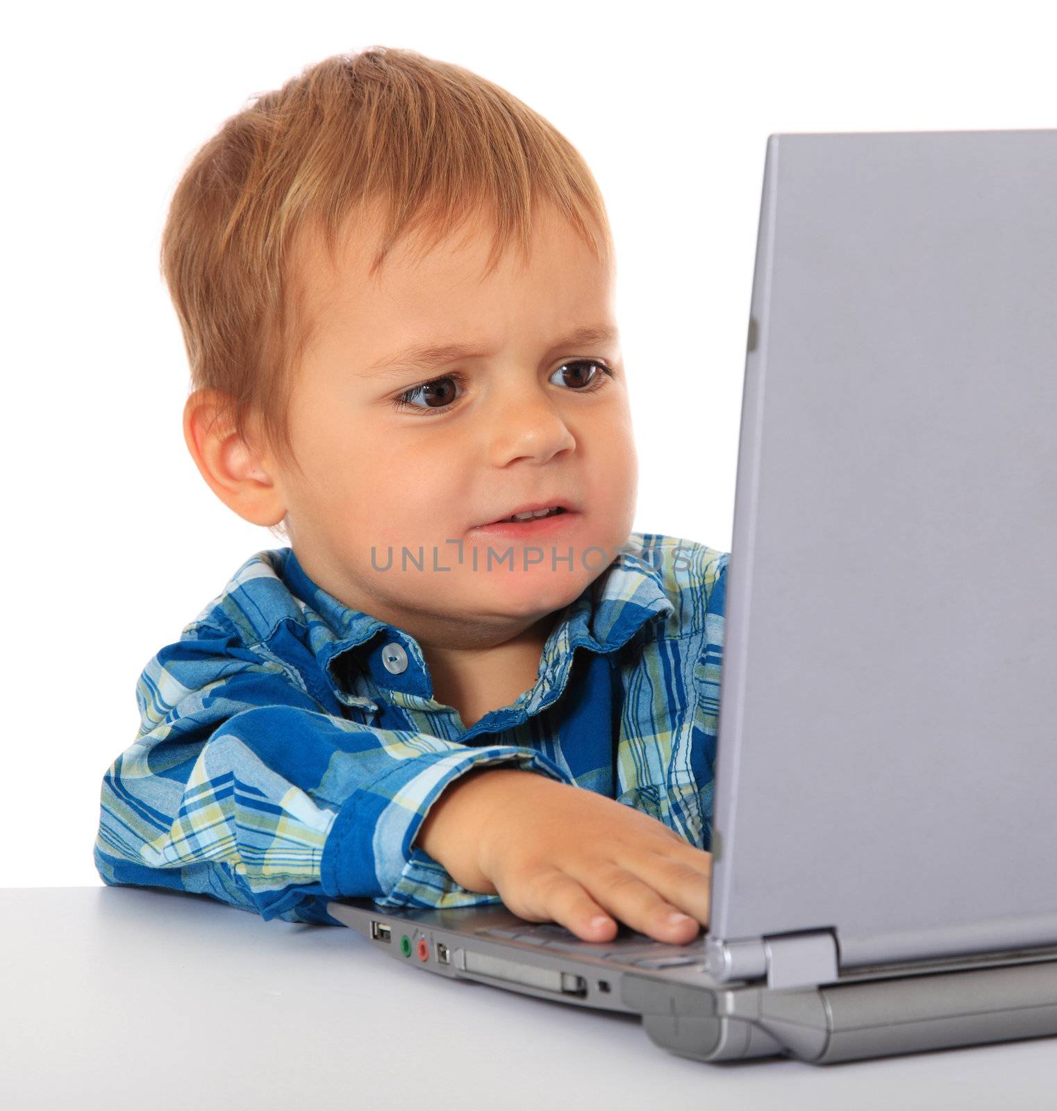 Cute caucasian boy cant handle a laptop. All on white background.
