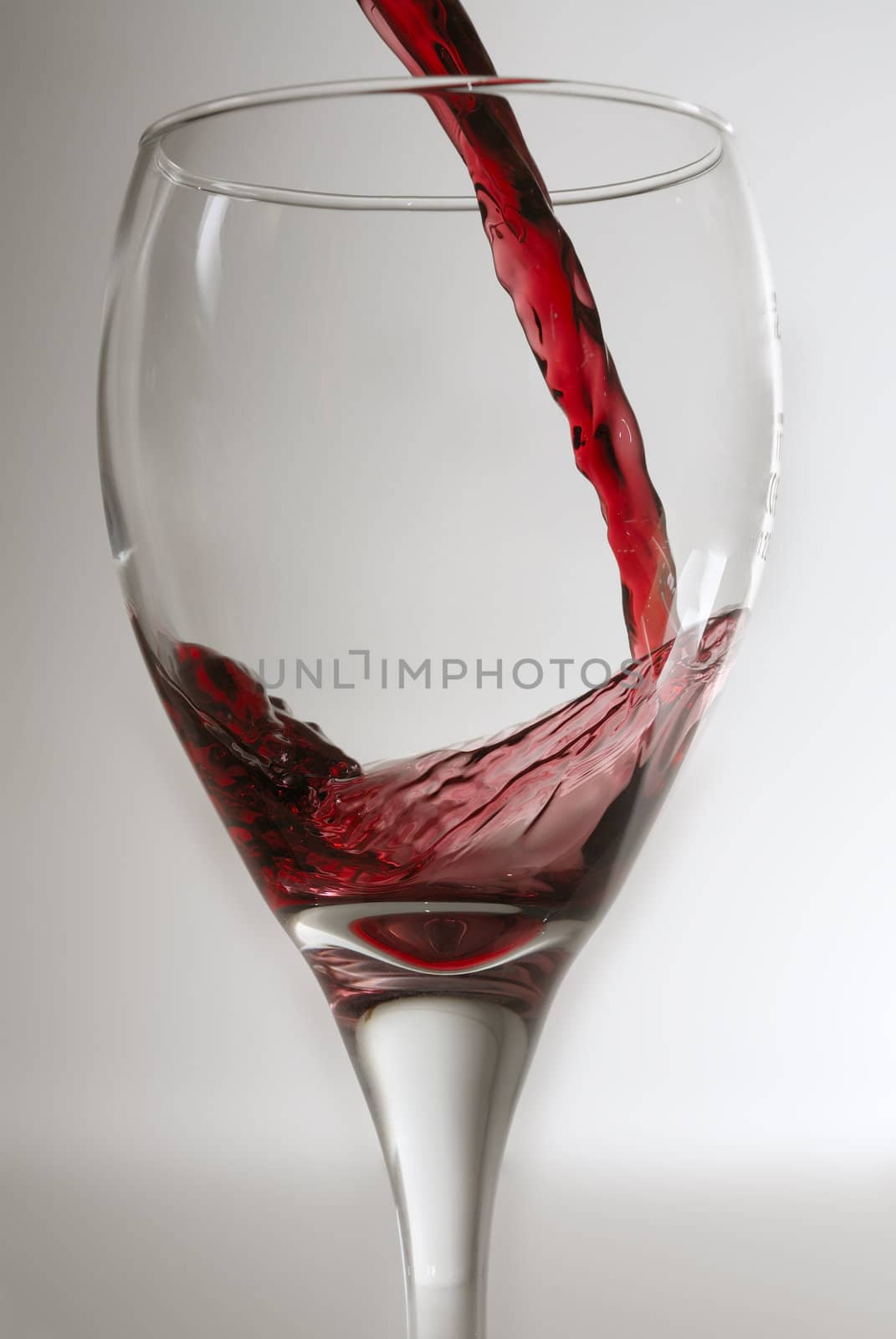 Pouring red wine. by swellphotography