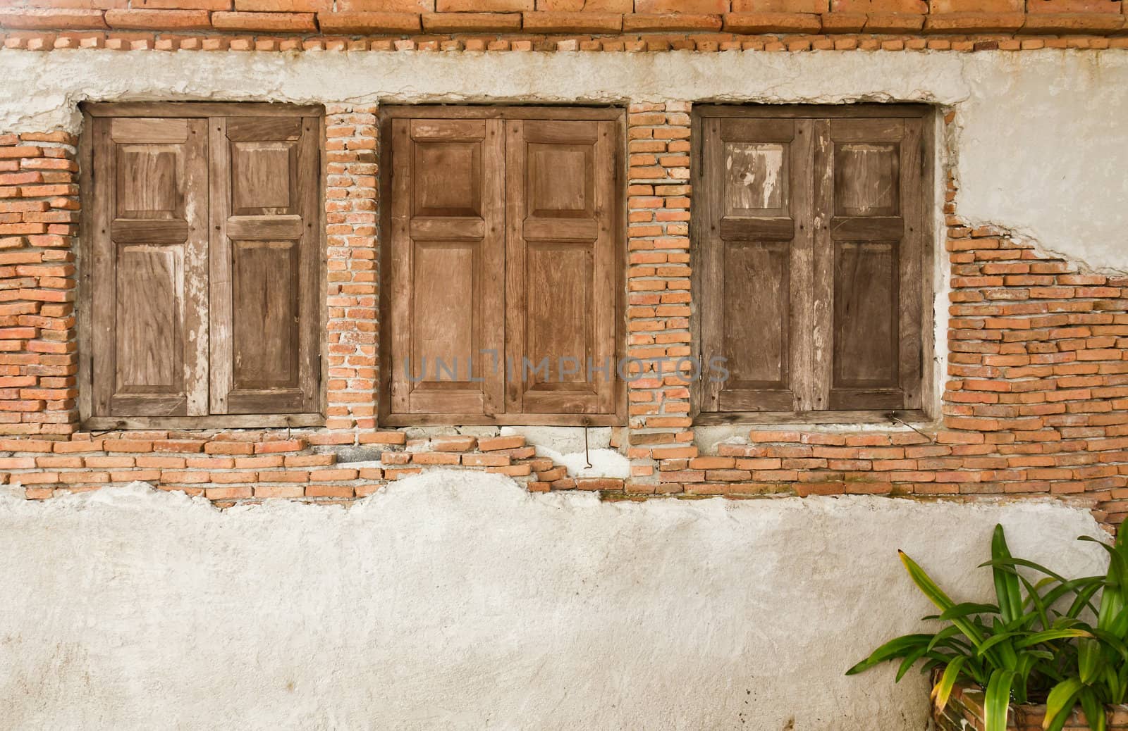 Old wooden window on old brick wall