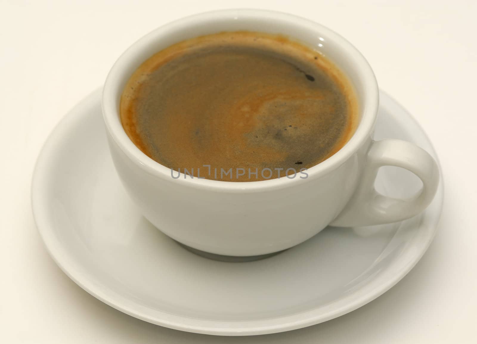 One cup of coffee and saucer on white background