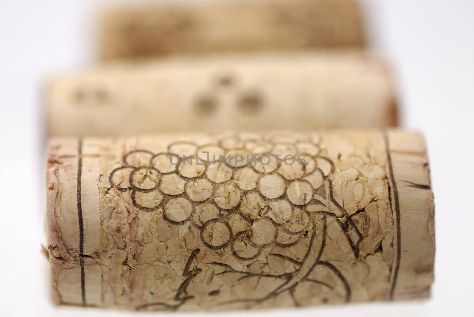 Simple studio shot of three wine corks. Focus on 1st cork, shallow DOF.