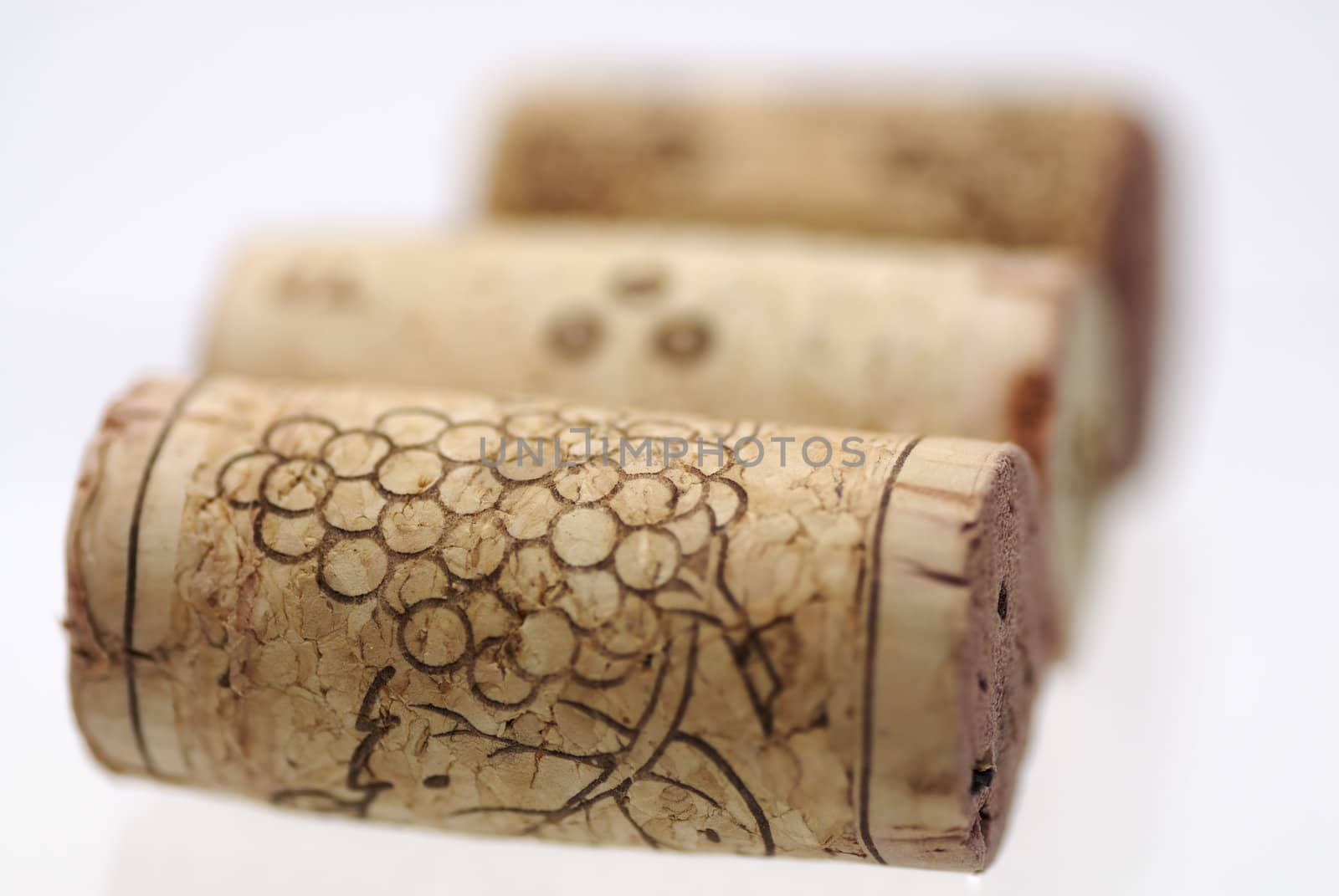 Simple studio shot of three wine corks. Focus on 1st cork, shallow DOF.