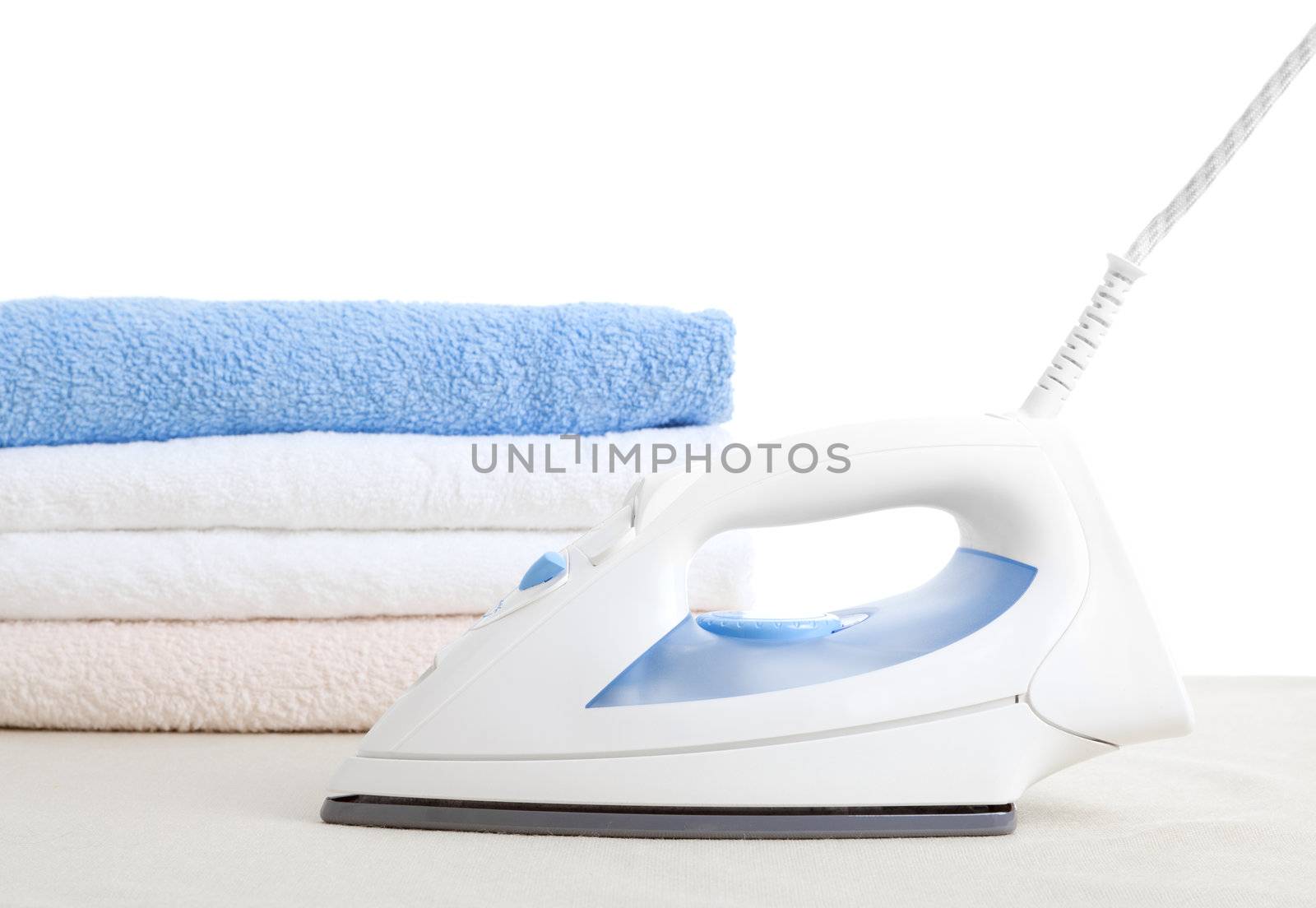 electric iron and towels, on white background 