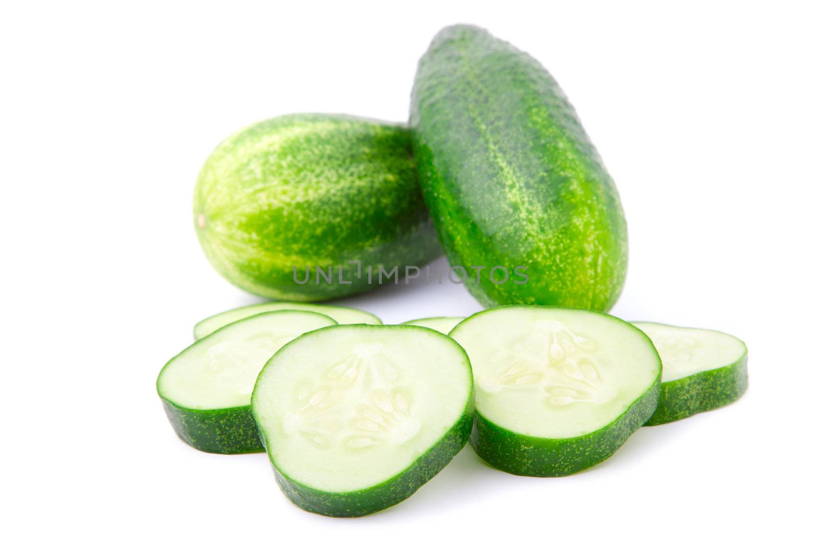 Cucumber and slices isolated over white background.  by motorolka