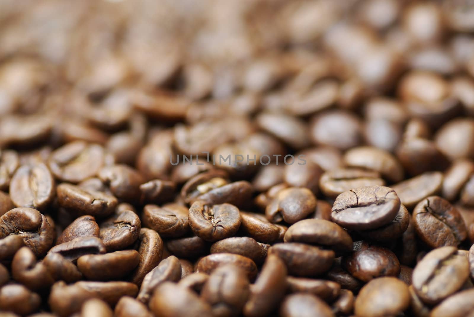 Pile of decaffinated coffee beans, short DOF focus on foreground.