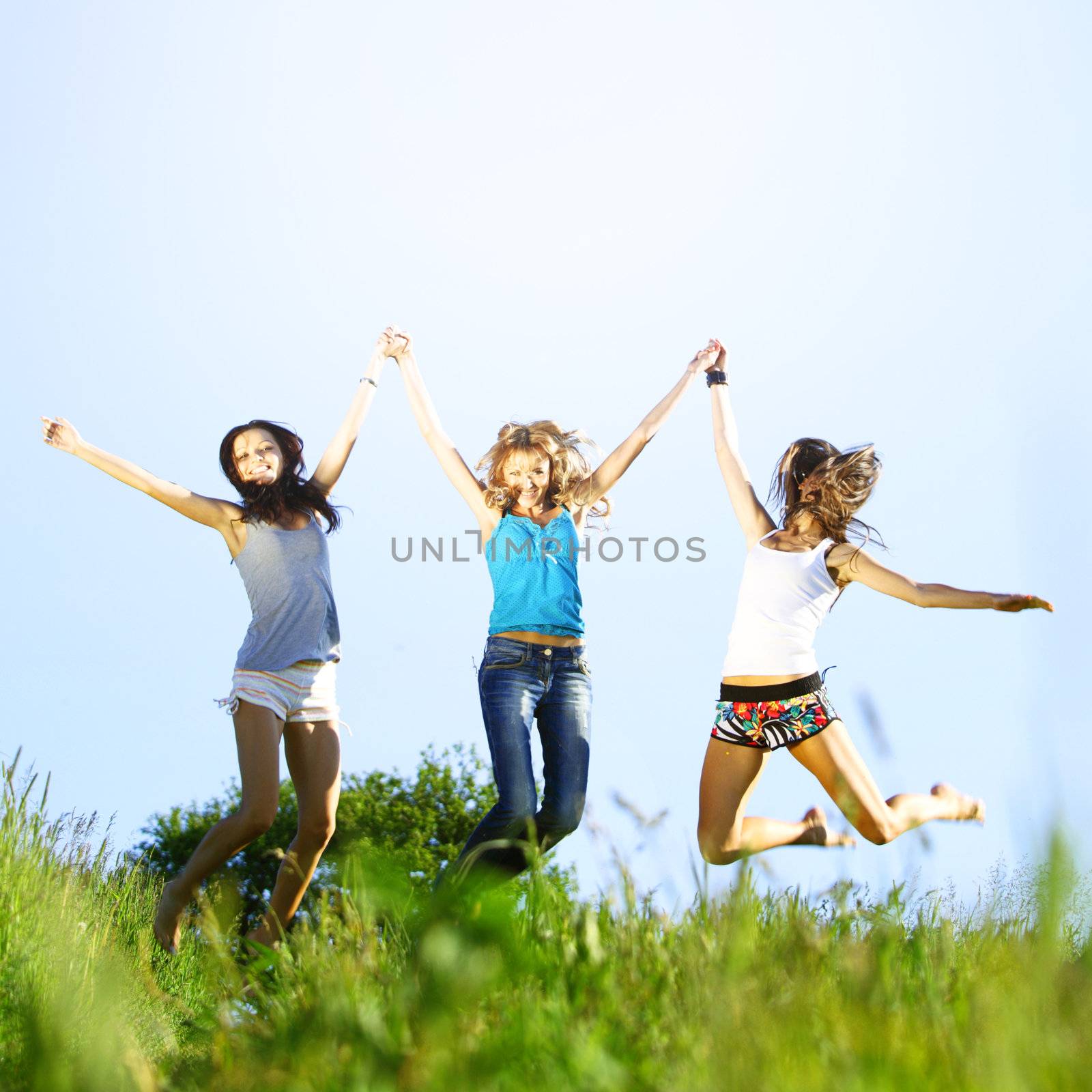 fun smile girlfriends jump to sky