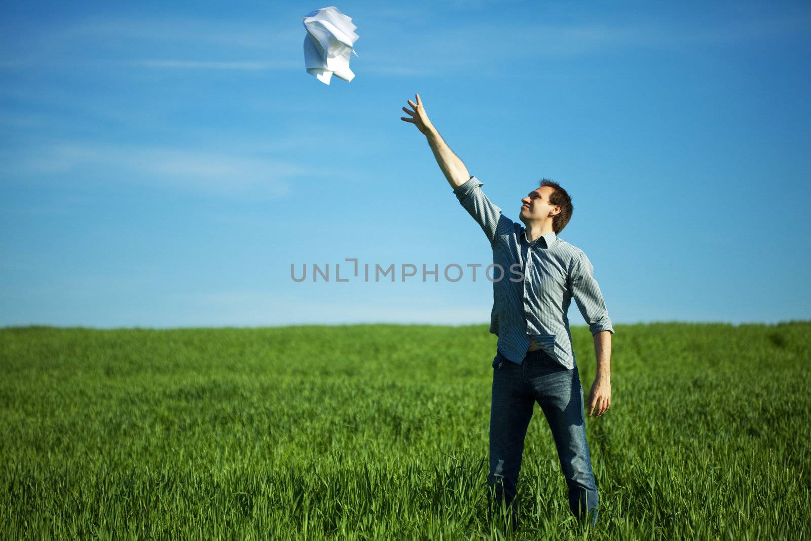 man throws the paper in the field