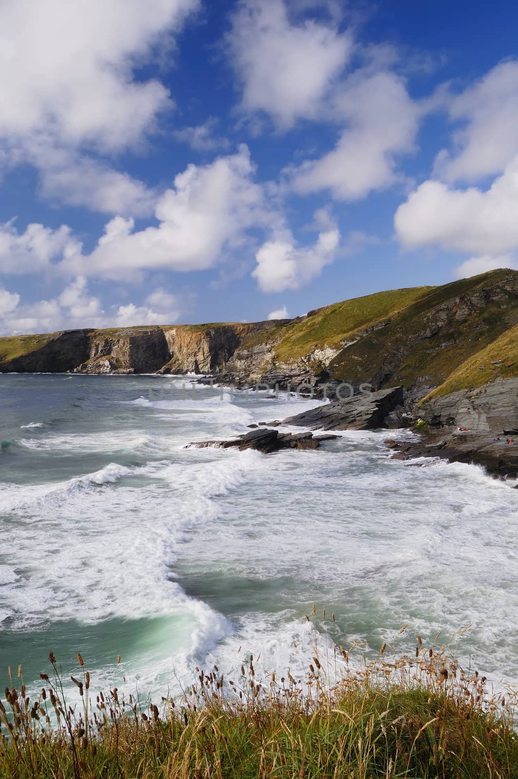 Vertical photograph of a Stormy Sea and Blue Sky, Trebarwith Strand, Cornwall, UK.
