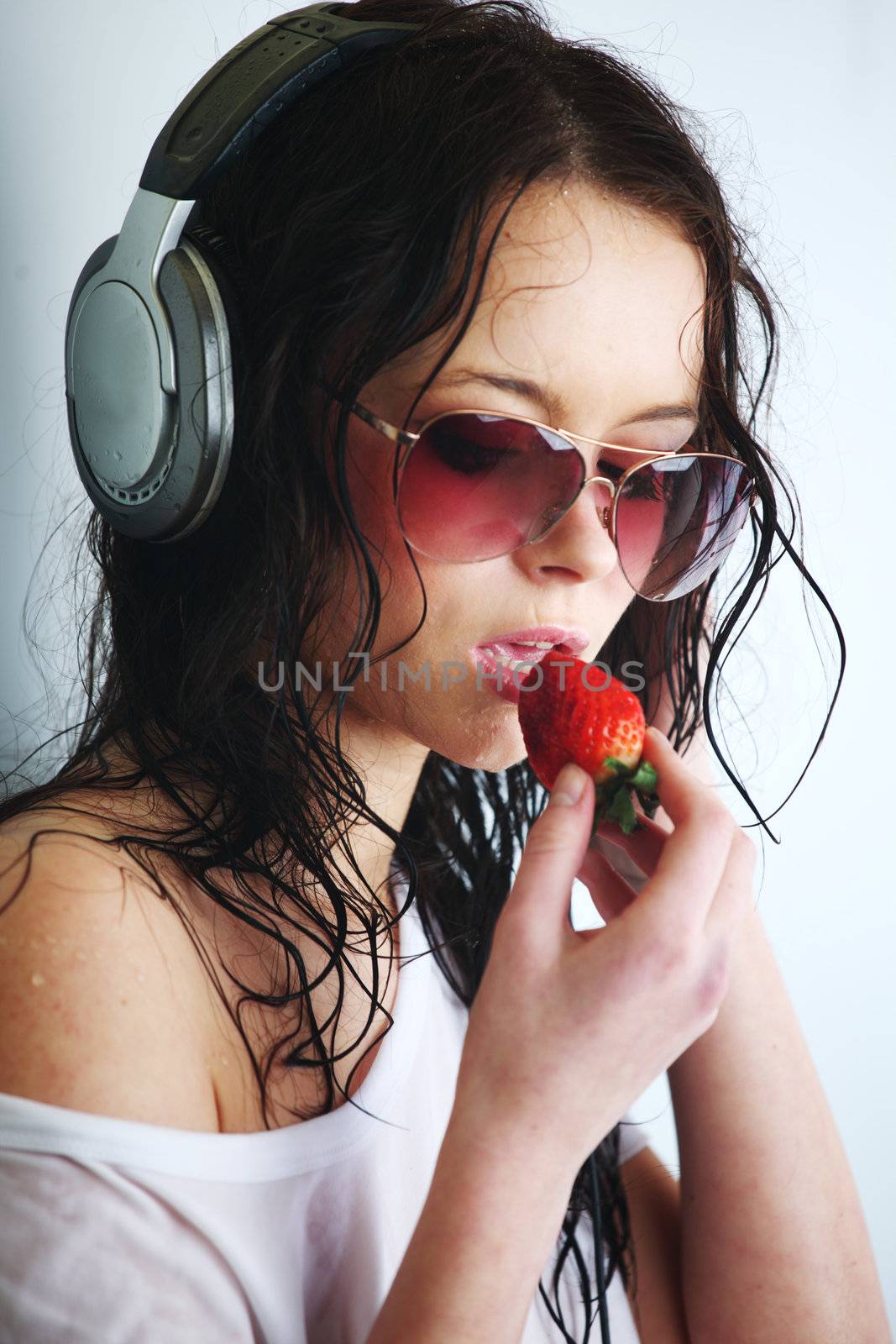 happy woman dance in phones and eat strawberry