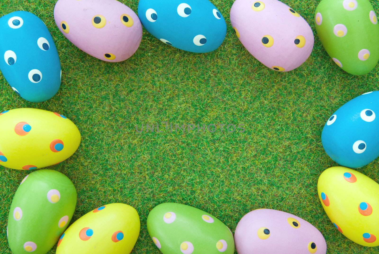 Easter eggs border on a grass lawn
