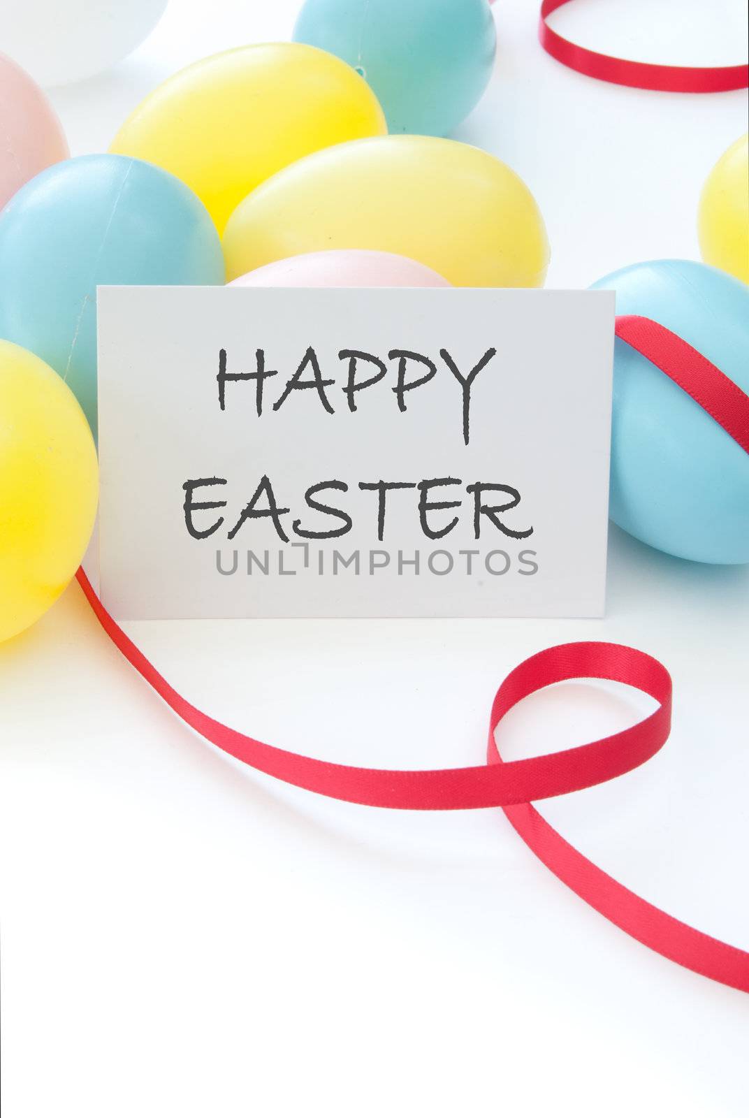 Pastel coloured easter eggs with a happy easter greeting card 