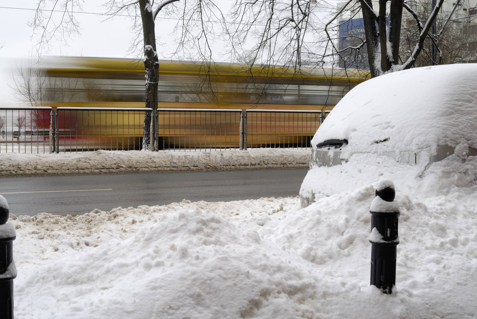 Blurred tram in the background of a wintery scene in Warsaw,  Poland.