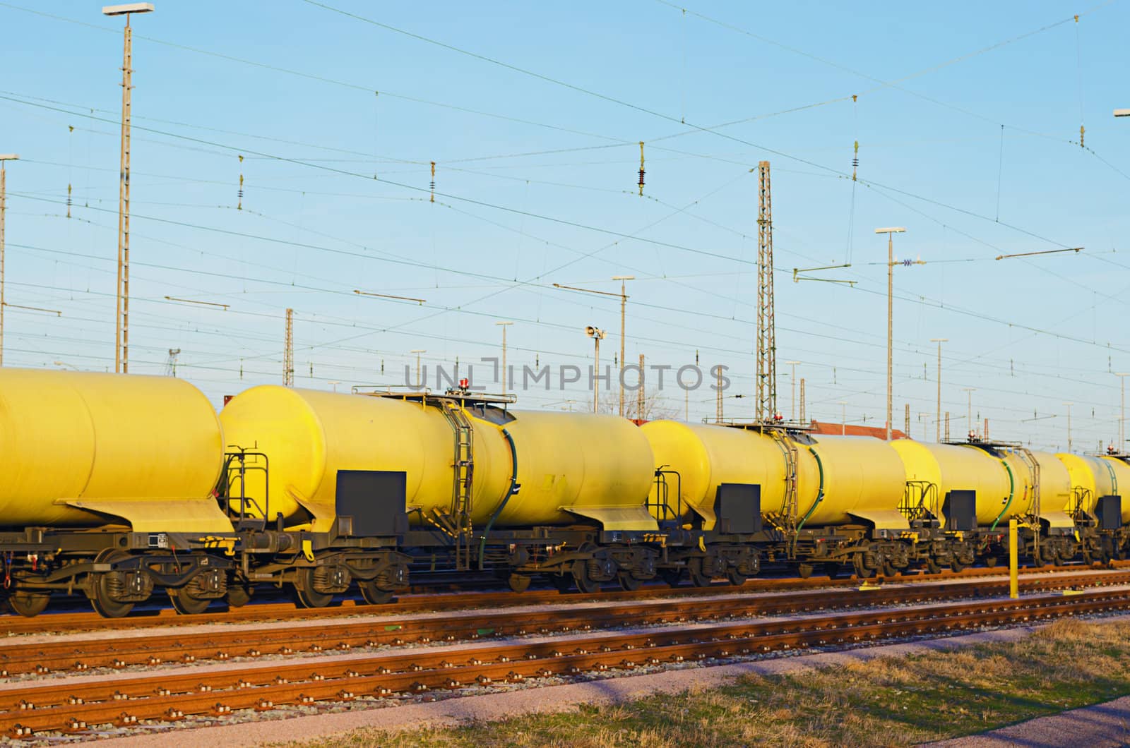 A yellow freight train on a freight yard.