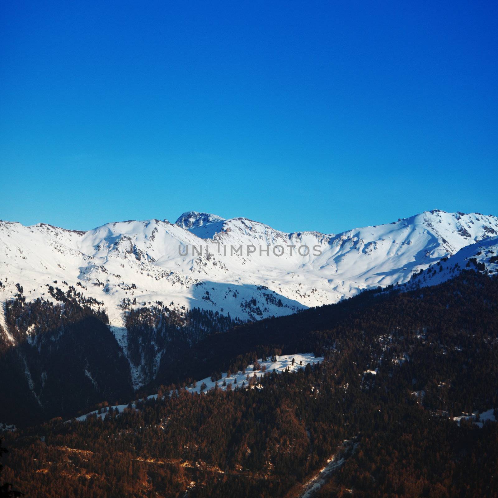 top of mountains sun in blue sky