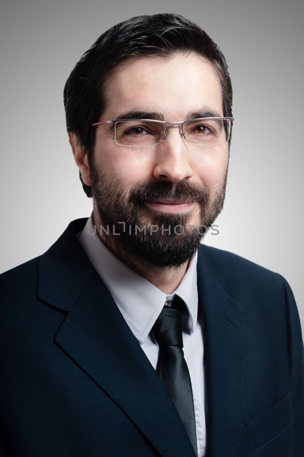 elegant bearded success business man on gray background