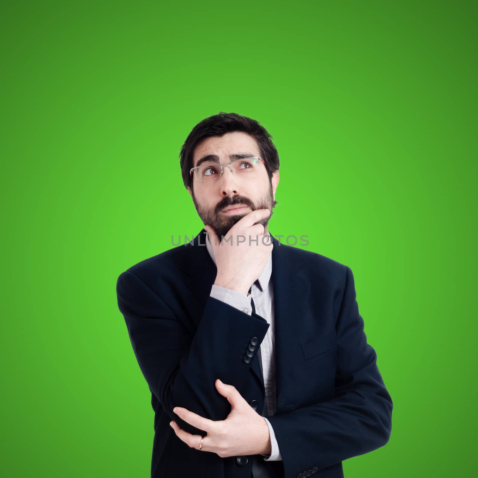 doubtful businessman on green background