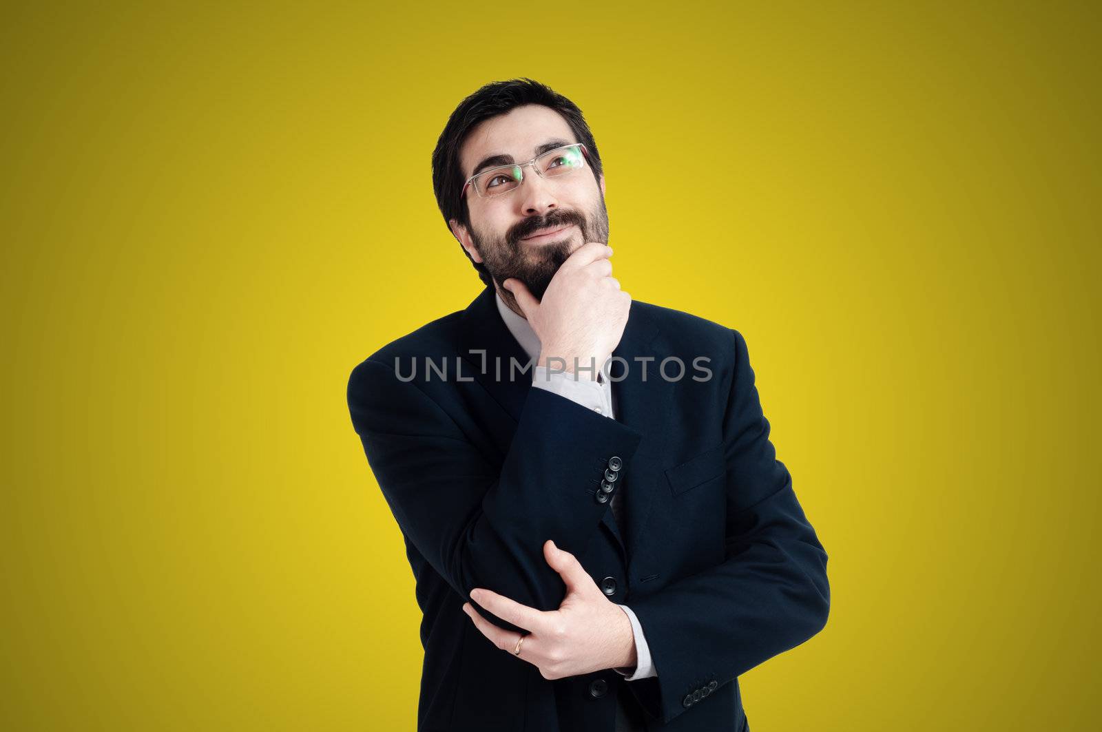 doubtful businessman on yellow background