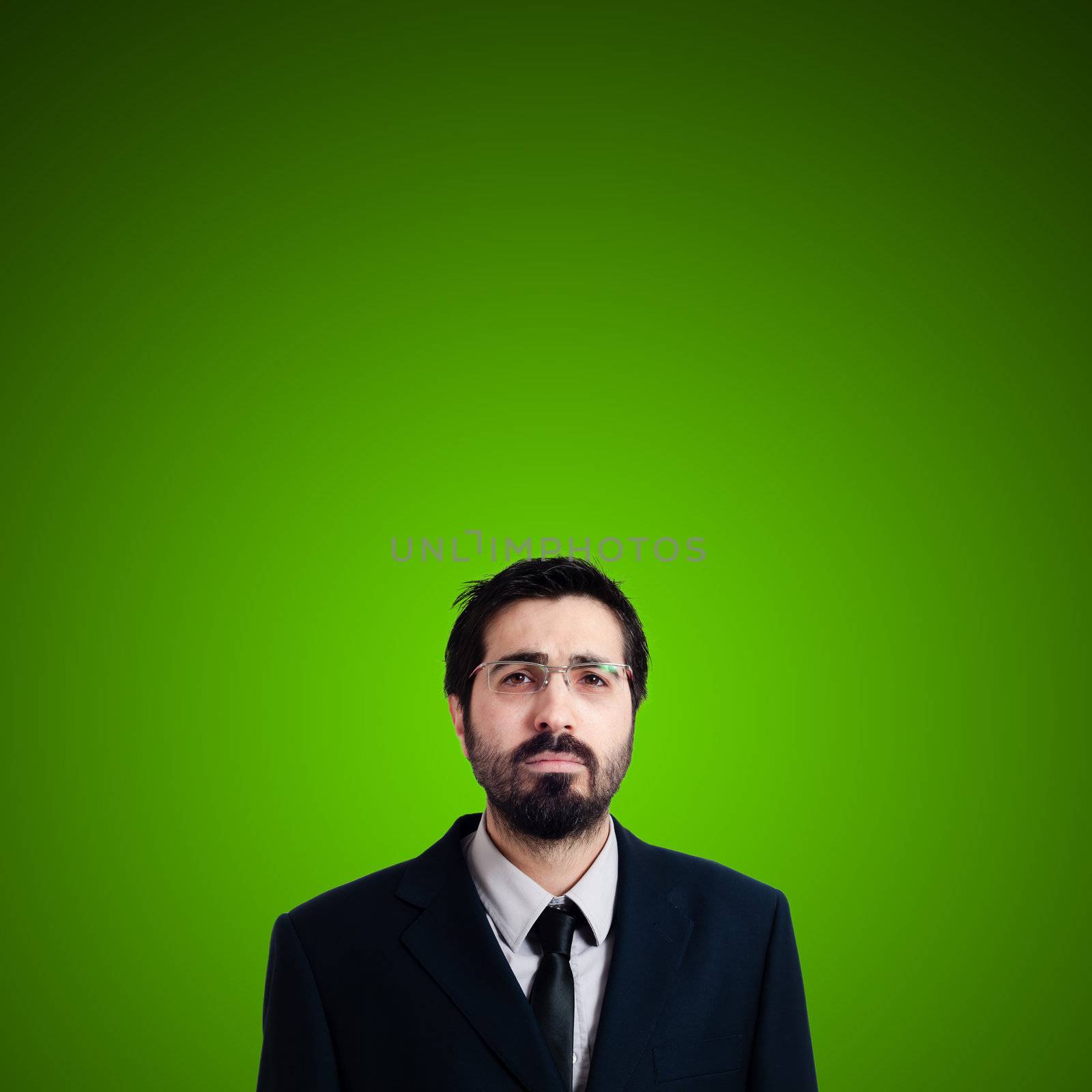 sad businessman on green background