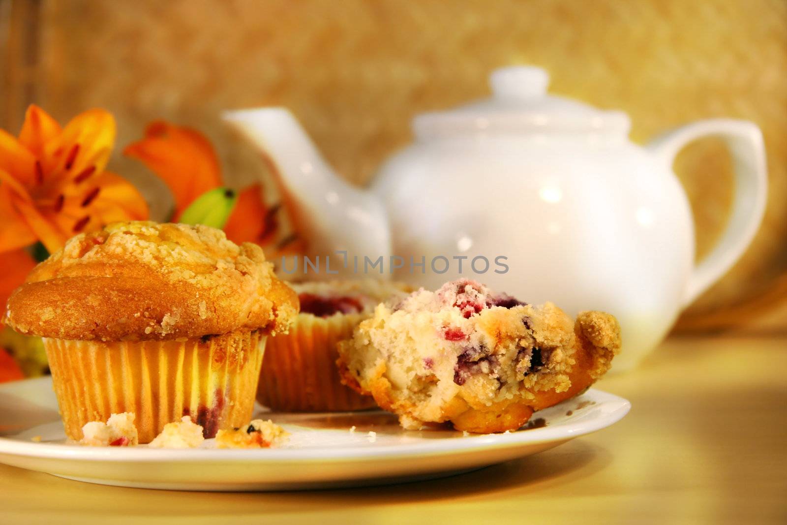 Healthy breakfast with cranberry muffins, tea and orange juice on bamboo mat