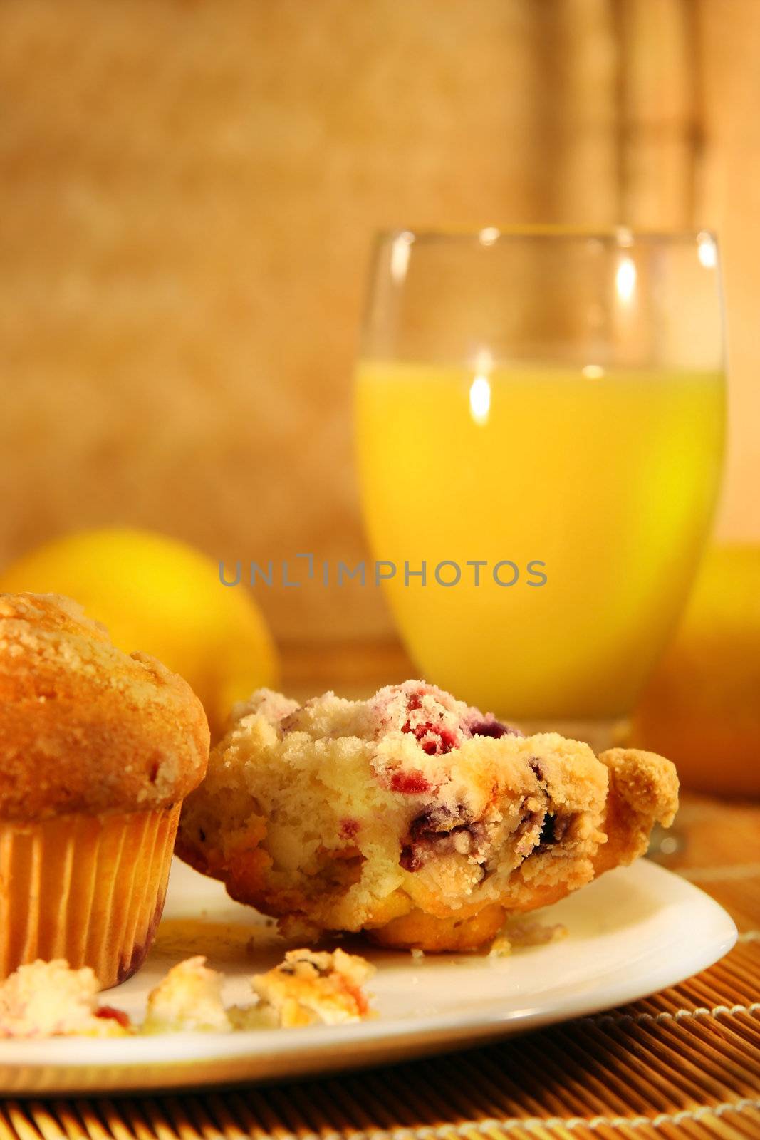 Healthy breakfast with cranberry muffins and orange juice on bamboo mat
